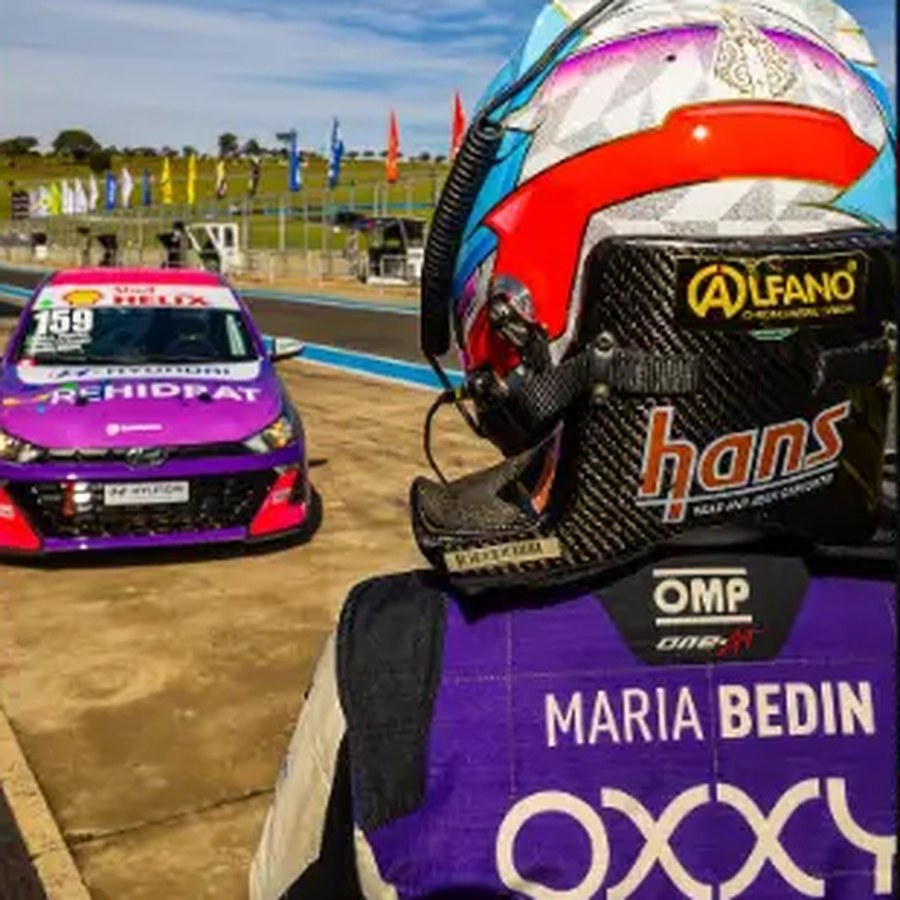 Capacete de Maria Bedin apoiado no macacão OXXY